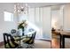 Bright dining room featuring modern light fixture, glass table and views to another living area at 620 Glen Iris Dr # 223, Atlanta, GA 30308