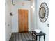 Inviting entryway with wood door, decorative mirror, and a stylish geometric rug; creating a warm and welcoming entrance at 620 Glen Iris Dr # 223, Atlanta, GA 30308