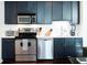 Kitchen featuring stainless steel appliances, dark blue cabinets, and white countertops at 620 Glen Iris Dr # 223, Atlanta, GA 30308
