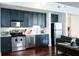 The open kitchen has stainless appliances and dark cabinets at 620 Glen Iris Dr # 223, Atlanta, GA 30308