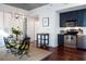 Open concept kitchen features modern appliances, dark cabinets, and an adjacent dining area with unique light fixture at 620 Glen Iris Dr # 223, Atlanta, GA 30308