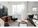 Comfortable living room with seating, a large window, and a TV at 620 Glen Iris Dr # 223, Atlanta, GA 30308