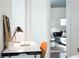 Bright office featuring a sleek white desk, wooden chair, and view into the modern living area at 620 Glen Iris Dr # 223, Atlanta, GA 30308