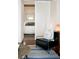 A cozy sitting area with a black chair and blue patterned rug, adjacent to the bedroom, providing a private retreat at 620 Glen Iris Dr # 223, Atlanta, GA 30308
