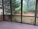 Inviting screened back porch with a brown wood railing and a backyard view with privacy fence at 2552 White Oak Dr, Decatur, GA 30032