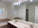 Bathroom featuring double sinks, bathtub, shower, and neutral tile surround at 2552 White Oak Dr, Decatur, GA 30032