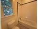 Bathroom featuring tile flooring, a bathtub, and a window overlooking lush greenery at 2552 White Oak Dr, Decatur, GA 30032