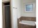 Bathroom with a soaking tub, separate shower, and a privacy glass block window at 2552 White Oak Dr, Decatur, GA 30032