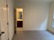 Bedroom with neutral walls and carpet that leads to a full bathroom with tile flooring at 2552 White Oak Dr, Decatur, GA 30032