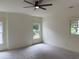 Bright bedroom features large windows, neutral paint, carpeted flooring, and a modern ceiling fan at 2552 White Oak Dr, Decatur, GA 30032
