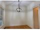 Neutral dining room featuring hardwood floors, a modern light fixture, white walls, and bright lighting at 2552 White Oak Dr, Decatur, GA 30032