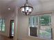 Bright entryway featuring hardwood floors, modern light fixture, large windows, and white trim at 2552 White Oak Dr, Decatur, GA 30032