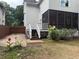 The home features a screened porch, stairs to the backyard, and a parking area behind a wooden fence at 2552 White Oak Dr, Decatur, GA 30032