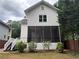 View of the home's exterior, featuring a screened porch, stairs to the backyard, and some landscaping at 2552 White Oak Dr, Decatur, GA 30032