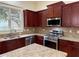 This kitchen has stainless appliances, granite countertops, and dark wood cabinetry at 2552 White Oak Dr, Decatur, GA 30032