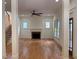 Open-concept living room with hardwood floors, a fireplace, white trim, and abundant natural light at 2552 White Oak Dr, Decatur, GA 30032