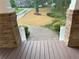 Exterior view from the porch featuring brick and white pillars, brown deck, and a well-manicured front yard at 2552 White Oak Dr, Decatur, GA 30032