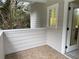 Cozy porch with tile flooring, white siding, and a view of trees at 2552 White Oak Dr, Decatur, GA 30032