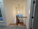 Bright staircase features carpeted steps, wooden banister, and a modern light fixture at 2552 White Oak Dr, Decatur, GA 30032