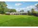 Expansive backyard with a well-maintained lawn and a view of the house's rear exterior at 3280 Pebble Hill Dr, Marietta, GA 30062