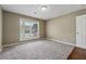 Relaxing bedroom space, featuring neutral carpet and walls, with a large window for ample natural light at 3280 Pebble Hill Dr, Marietta, GA 30062