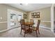 Cozy dining area with a round wood table, seating for four, and a door leading to the outside at 3280 Pebble Hill Dr, Marietta, GA 30062