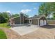 Exterior view of home with a two-car garage, a chimney, and a circular driveway at 3280 Pebble Hill Dr, Marietta, GA 30062