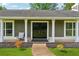 Close-up of a charming front porch with decorative plants and seating area at 3280 Pebble Hill Dr, Marietta, GA 30062