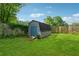 Charming backyard shed with blue doors, offering storage space and nestled amidst greenery at 3280 Pebble Hill Dr, Marietta, GA 30062