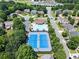Aerial view showcasing community pool, tennis courts, and surrounding neighborhood at 4665 Idlewood Dr, Cumming, GA 30040