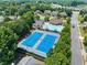 Aerial view showcasing the community pool, tennis courts, and surrounding residential area at 4665 Idlewood Dr, Cumming, GA 30040