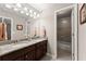 Bathroom featuring a double sink vanity, granite counters, and a shower-tub combo at 4665 Idlewood Dr, Cumming, GA 30040