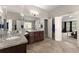 Bright bathroom with double vanity, granite counters and view to bedroom at 4665 Idlewood Dr, Cumming, GA 30040