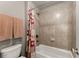 Bathroom with tiled shower-tub combo and matching accents at 4665 Idlewood Dr, Cumming, GA 30040