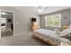 Cozy bedroom features a neutral color palette and a large window for natural light at 4665 Idlewood Dr, Cumming, GA 30040