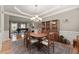 Traditional dining room with hardwood floors, a chandelier, and a piano visible in the background at 4665 Idlewood Dr, Cumming, GA 30040