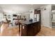 Open-concept kitchen adjacent to the dining and living areas, featuring granite countertops and hardwood floors at 4665 Idlewood Dr, Cumming, GA 30040
