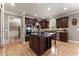 Gourmet kitchen boasts dark wood cabinets, granite countertops, stainless steel appliances, and hardwood floors at 4665 Idlewood Dr, Cumming, GA 30040