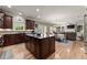 Spacious kitchen with a center island, granite counters, stainless appliances, and an open view into the living space at 4665 Idlewood Dr, Cumming, GA 30040