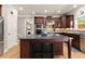 Well-appointed kitchen showcasing dark wood cabinetry, stainless appliances, granite countertops, and a functional center island at 4665 Idlewood Dr, Cumming, GA 30040
