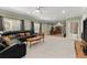 Comfortable living room featuring carpeted floors and a large leather sectional at 4665 Idlewood Dr, Cumming, GA 30040
