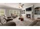 Relaxing living room featuring a fireplace with built-ins, hardwood flooring, and plush seating arrangements at 4665 Idlewood Dr, Cumming, GA 30040