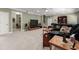 Spacious living room with carpet, and a comfortable black leather sofa at 4665 Idlewood Dr, Cumming, GA 30040