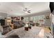 Inviting living room with hardwood floors, a ceiling fan, and an open view into the kitchen area at 4665 Idlewood Dr, Cumming, GA 30040