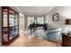 Elegant living room featuring hardwood floors, a grand piano, and display cabinet for showcasing cherished collectibles at 4665 Idlewood Dr, Cumming, GA 30040