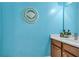 Bright powder room with a blue accent wall, unique shell decor, and modern vanity at 630 Birch River Ln, Lawrenceville, GA 30043