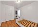 Minimalist bedroom with hardwood floors and two white doors at 630 Birch River Ln, Lawrenceville, GA 30043