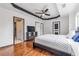 Primary bedroom features a tray ceiling, fan, hardwood floors, and access to a private bathroom at 630 Birch River Ln, Lawrenceville, GA 30043