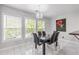 Dining area with a modern chandelier, large windows offering a bright view, and minimalist design at 630 Birch River Ln, Lawrenceville, GA 30043