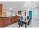 Kitchen breakfast bar with granite countertop, sleek modern dining table, and stainless steel refrigerator at 630 Birch River Ln, Lawrenceville, GA 30043